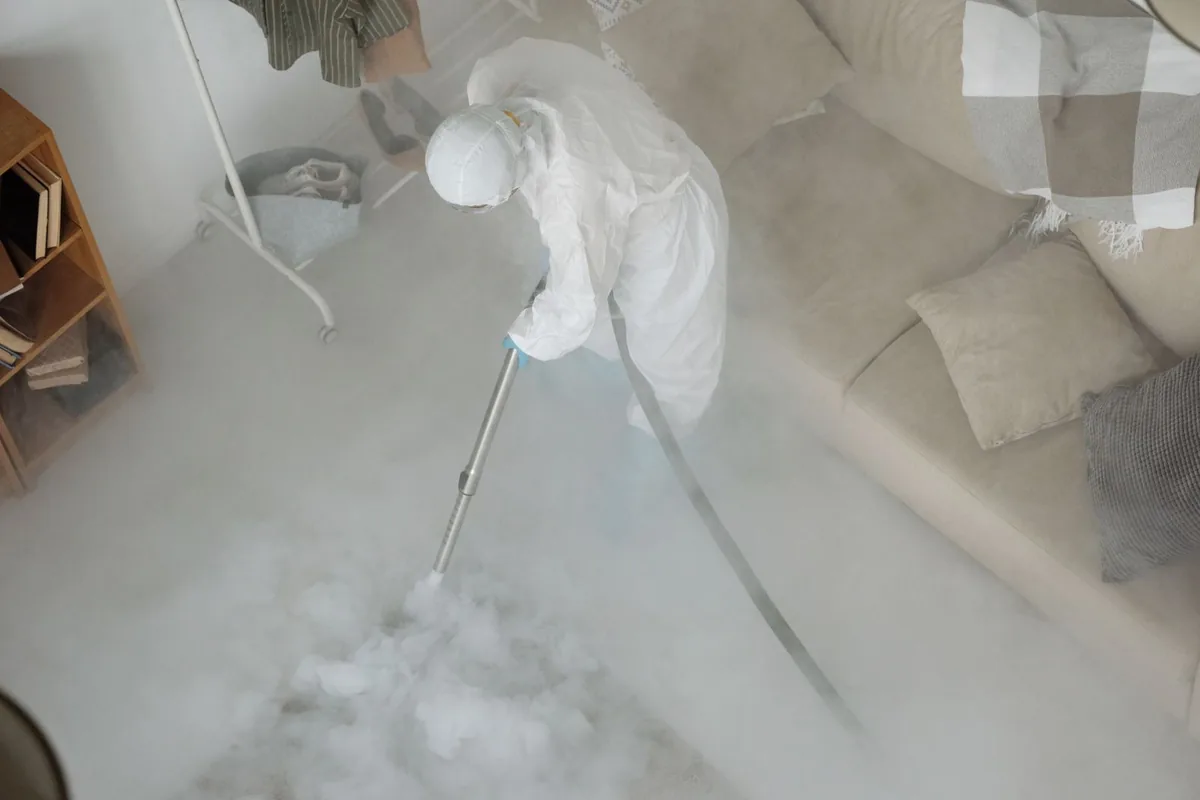 Biohazard cleanup technician in protective equipment, Munday, TX
